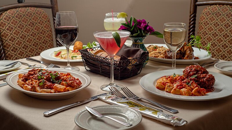 Multiple entrees and cocktails on a set table